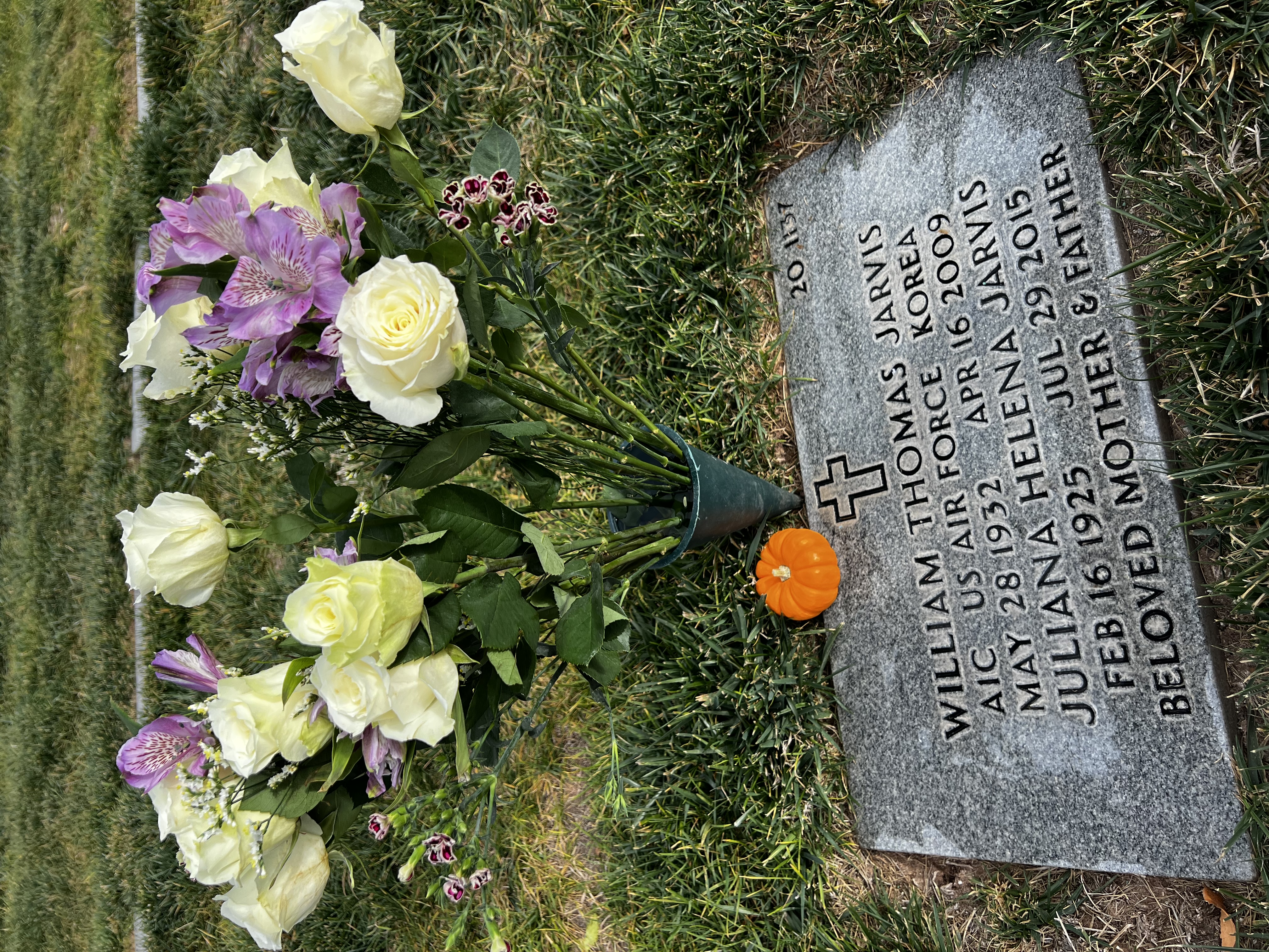 Gravesite care with white and purple roses